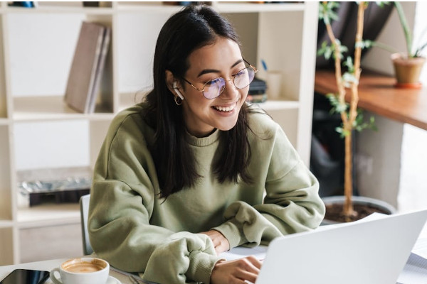 Woman smiling at her laptop